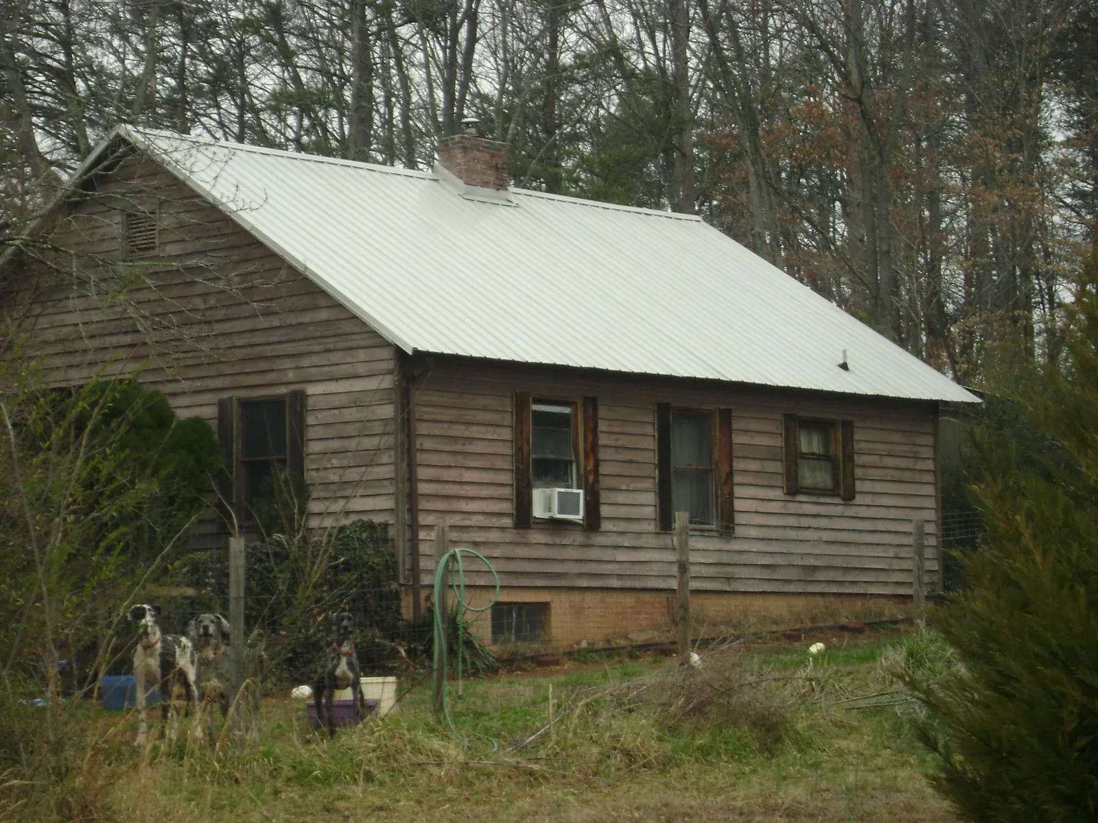 White metal roof on an old wood sided farmhouse, from a Metal Roof Installation job in Saltese